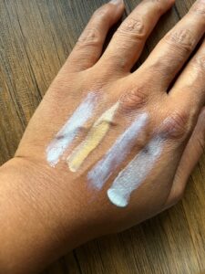 Showing what Moogoo, Mádara and Shade sunscreens look like on my hand